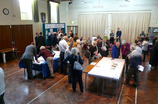 People discussing flood plans at a community event.